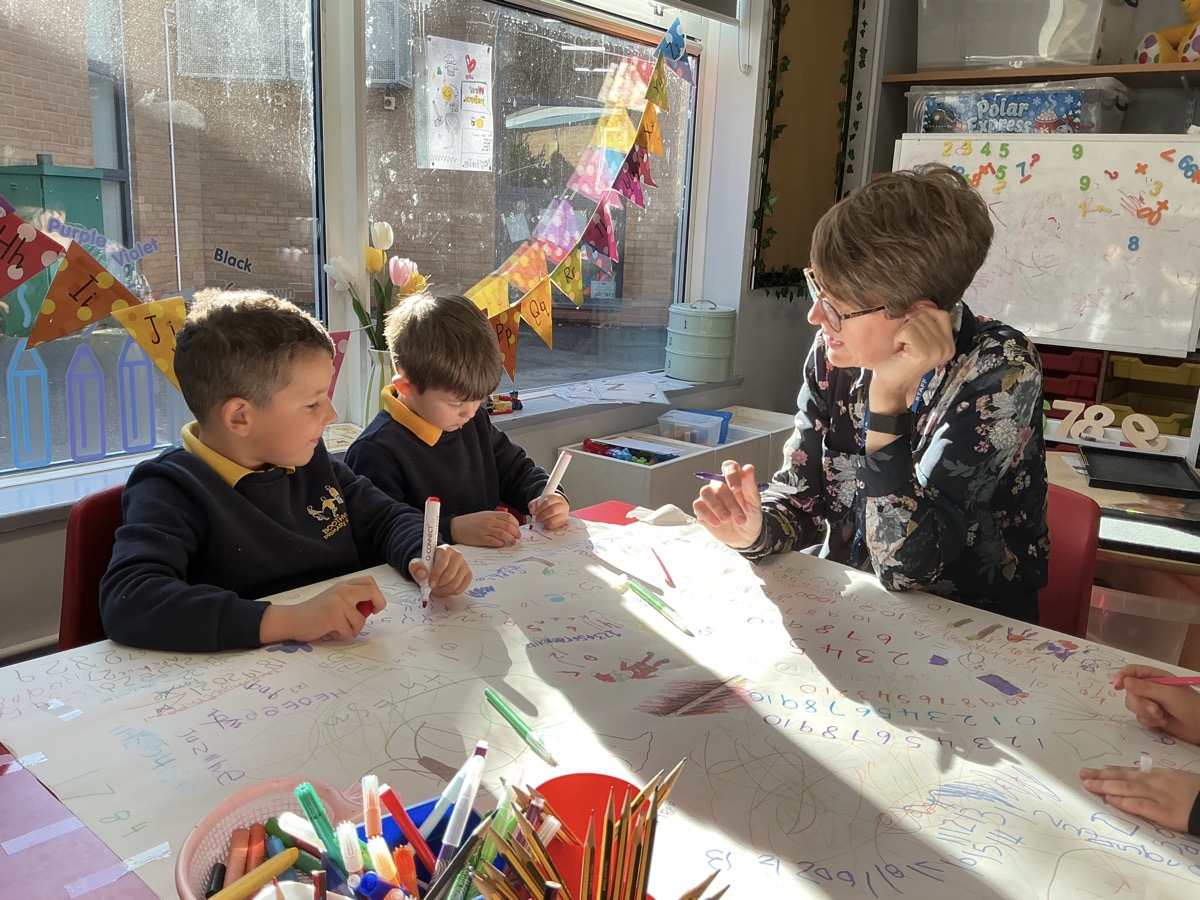The head teacher working with two pupils at Boothville Primary School. The head teacher working with two pupils at Boothville Primary School.